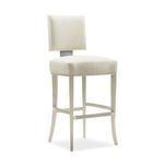 Bar stool angled slightly to side showing plush seat and soft silver painted frame