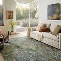 Living room scene with Anniston Lagoon Multi Rug beneath a sofa, decorated with neutral cushions and natural light