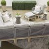 Similar outdoor scene as previous with different geometric concrete side table variant replacing pawn shape