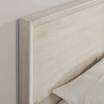Angled close-up of Reece Bed headboard corner showing smooth wood finish and framed design