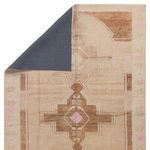 Back view of rug flipped corner revealing solid dark gray backing and front Southwestern design