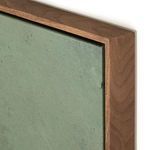 Close-up of walnut wood frame with visible wood grain and green painted canvas edge