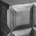 Close-up of the stippled black matte texture and crisp cubes on the Bower Side Table corner