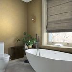 Wallpaper applied in a bathroom setting with freestanding tub, hexagonal floor tiles, and muted decor