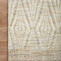 Close-up corner of Kenzie Ivory/Sand Rug on wood floor highlighting hand-woven details and edge