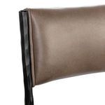 Focus on contoured, padded leather backrest with visible frame bevels