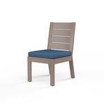 Laguna armless outdoor dining chair in hand-brushed aluminum with driftwood finish and blue seat cushion