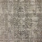 Close-up on central decorative motif with textured weave and softly faded colors