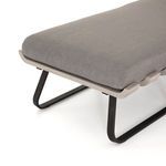 Close-up of daybed cushion edge and one black metal leg angled