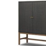 Low-angle side view focusing on antique brass hardware and open mahogany base