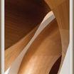 Fluid intertwined wooden curves in warm tones highlighting elegant architectural form in close-up