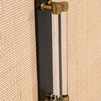 Close-up of brass and clear acrylic cylindrical handle on rattan door panel
