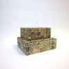Open small bone box atop closed larger box showcasing layered storage options
