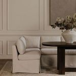 Banquette styled in dining room with wood table and floral centerpiece