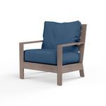 Laguna Club Chair with aluminum frame in driftwood finish and blue cushions with thick seat and back pillows