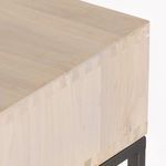 Side rear angled view showing slim dark metal base supporting solid poplar wood top