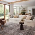 Graphite plaid rug styled in a bright living room beneath a white sofa with neutral throw pillows
