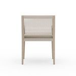 Back view depicting tightly spaced vertical woven ropes on chair backrest