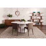 Dining room scene with Otago Oval Table surrounded by four brown fabric chairs on patterned rug and wooden shelves