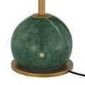 Close-up of green marble globe base with brass button and elegant swirling marble pattern