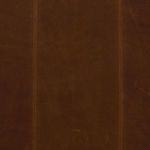 Extreme close-up of brown leather upholstery stitching and fine grain texture on back detail.