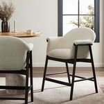 Sora Stool in kitchen setting beside round wooden table with window and decorative objects