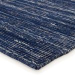 Close-up corner showing navy and cream woven texture and detailed edge stitching