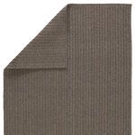 Corner of rug folded over to reveal backside weave pattern and texture