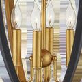 Detail view of gold leaf candle-style bulbs and central support rods inside black lantern frame