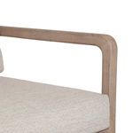 Close-up showing wooden armrest and beige fabric seat cushion junction
