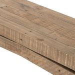 Close-up of reclaimed wood planks on leg showing nails, holes, and rough grain