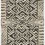 Top-down view showing full rectangular geometric pattern of the ivory and black tribal rug