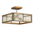Semi-flush ceiling light with gold mounting plate and clear glass sides seen from an angle