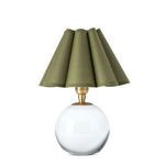 Compact table lamp with a white spherical base and green scalloped fabric shade with natural brass hardware