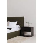 Close-up of Luzon Bed curved dark green upholstery frame and wooden short legs
