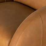 Close-up of top stitching detail along rounded armrest of chair