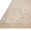 Side angle of the rug highlighting the flat weave texture, subtle blue accents, and detailed fringed edge
