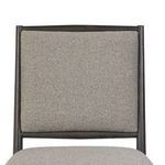 Close-up of square backrest upholstery with visible seam inside weathered oak frame
