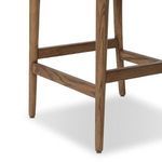 Close-up of rear right walnut leg and stretcher connecting the legs