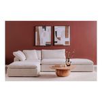 Living room setup featuring Clay ottoman as part of sectional sofa in front of burgundy wall