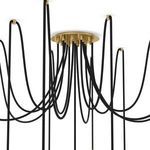 Overhead close-up of brass ceiling mount and multiple black cords suspending glass globes