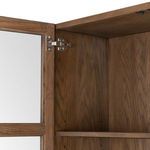 Hinge and glass panel detail inside door frame with visible wood texture