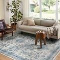 Heidi Ivory Ocean Rug styled under a beige sofa and leather chair in a bright living room