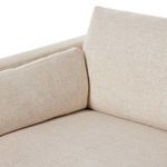 Close view of rounded armrest padding and loose back cushion stitching detail