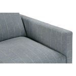Metered view down armrest to seat cushion, highlighting textured blue stripe fabric