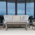 Laguna outdoor sofa set styled with two matching armchairs and a rectangular coffee table in patio setting