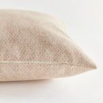 Side view focusing on concealed zipper along pillow edge and fabric detail