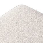 Top angled close-up of fabric texture highlighting small looped fibers of white bouclé