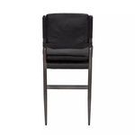 Back view of ebony black leather stool showing backrest texture and frame structure
