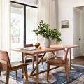 Heidi rug in dining room under light wood table and brown leather chairs, showing scale and room context